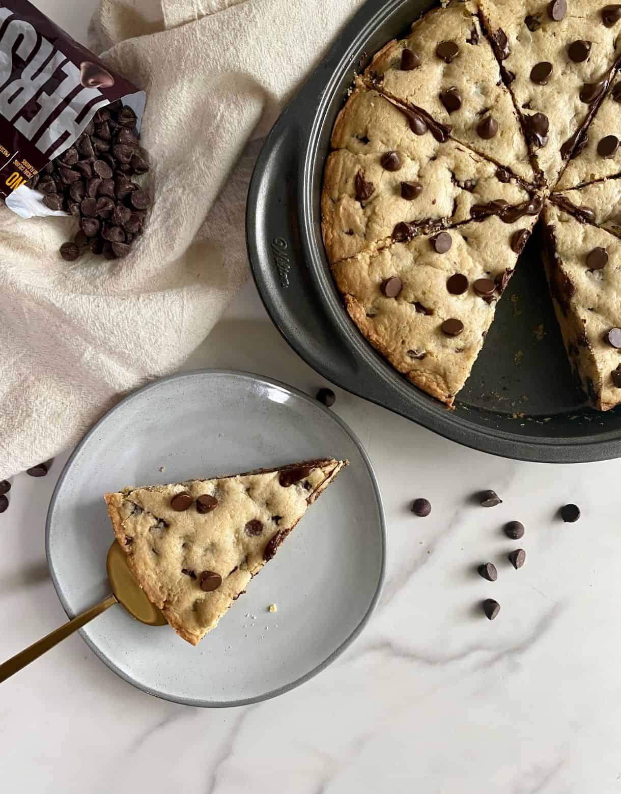 A cooked Deep Dish Cookie Pie with a piece cut out of it.