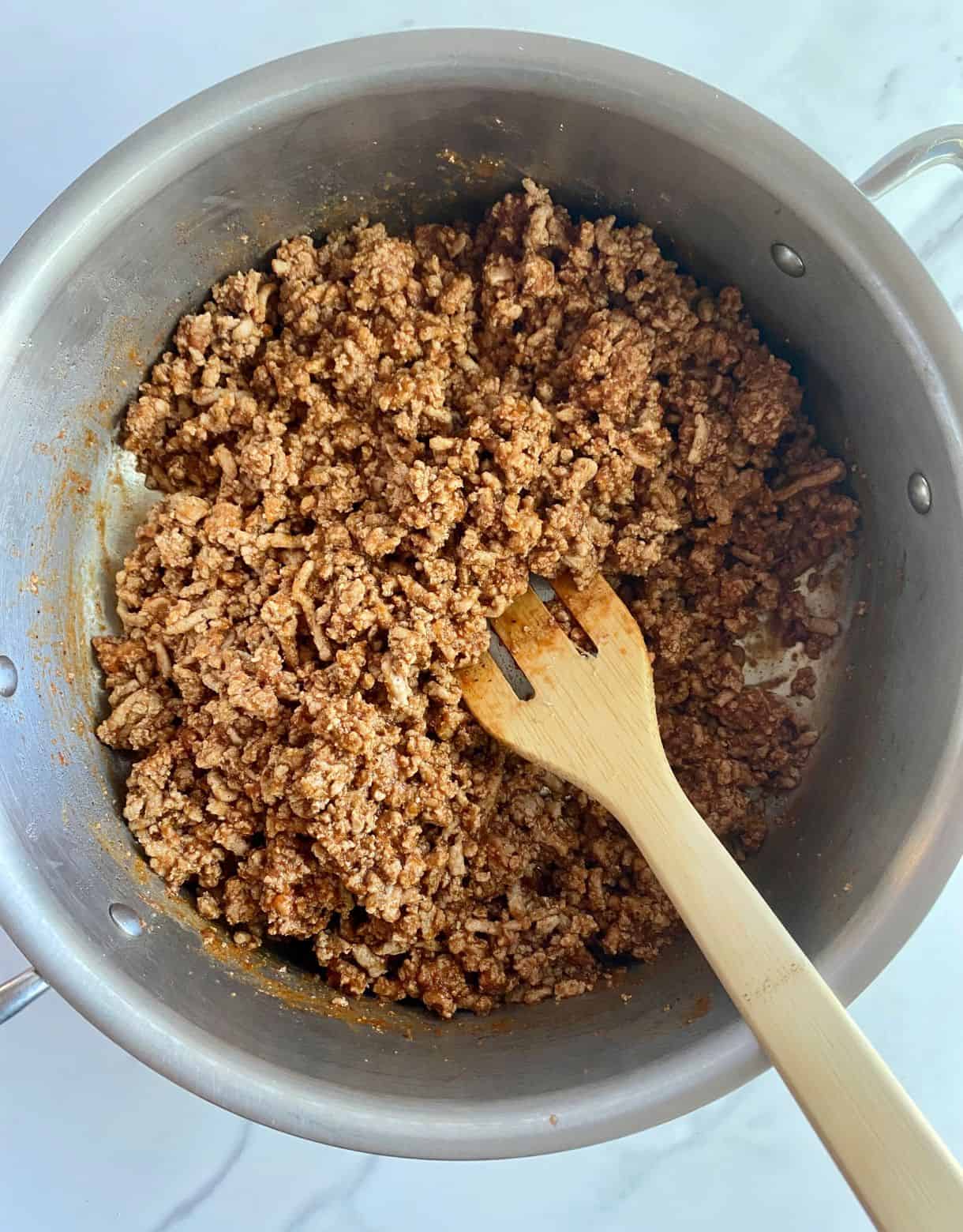A skillet of cooked and seasoned Turkey Taco Meat.