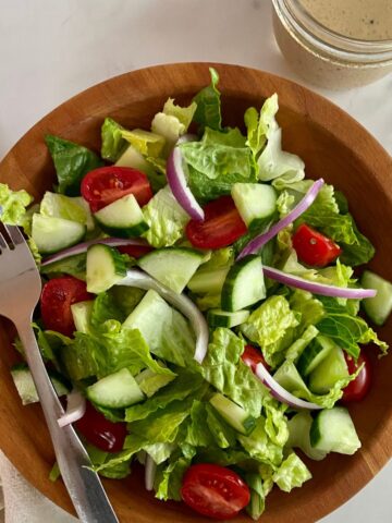A House Salad with a jar of Red Wine Vinaigrette.