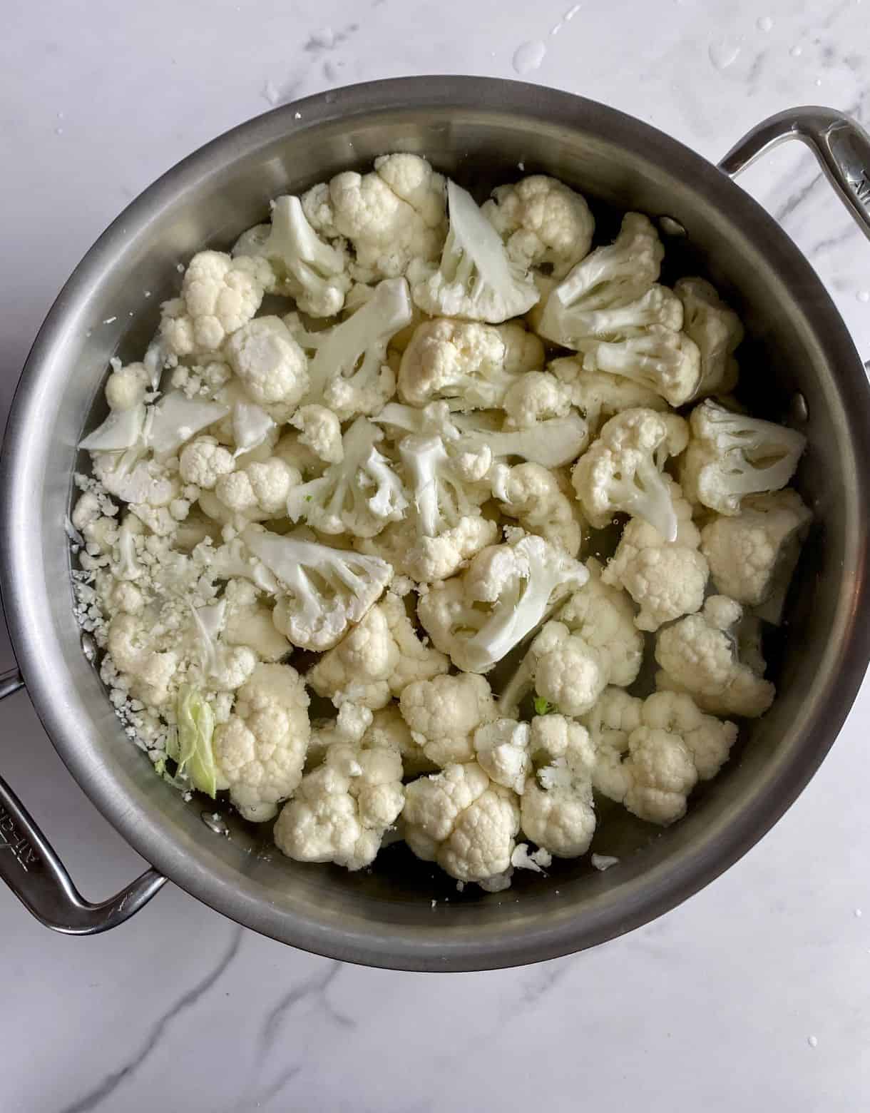 A pot of water with chopped cauliflower added.