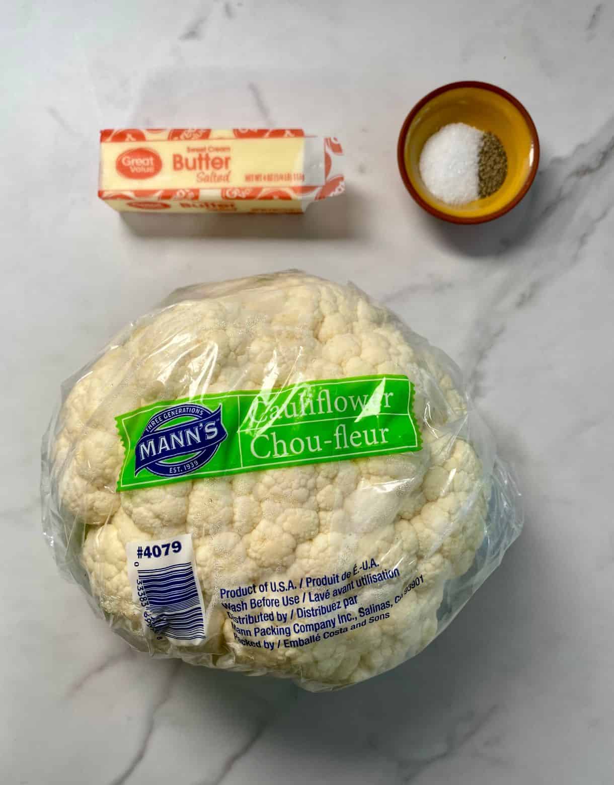 A head of cauliflower, a stick of butter, salt and pepper.