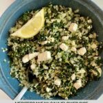 A dish with cooked Mediterranean Cauliflower Rice and a wedge of lemon.