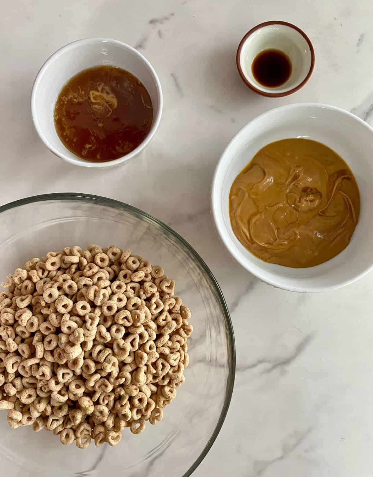 Bowls of Cheerios, peanut butter, honey and vanilla.