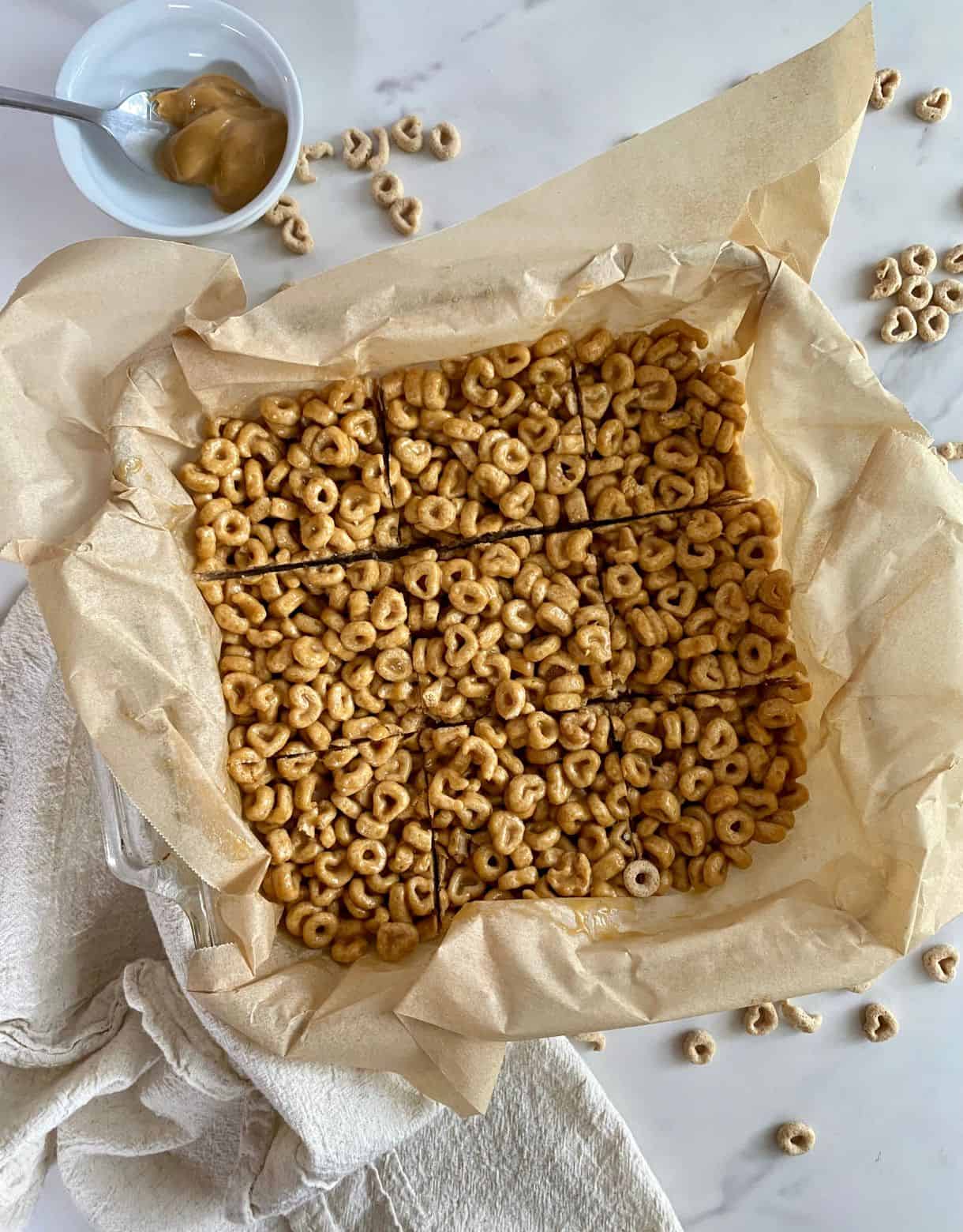 A pan of sliced Peanut Butter Cheerios Bars.