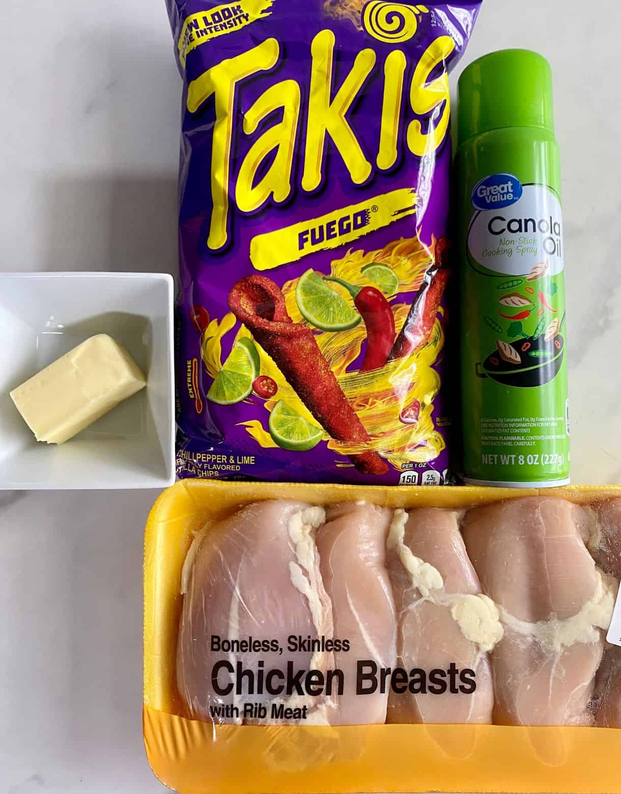 Chicken breasts, butter, cooking spray and a bag of Takis.