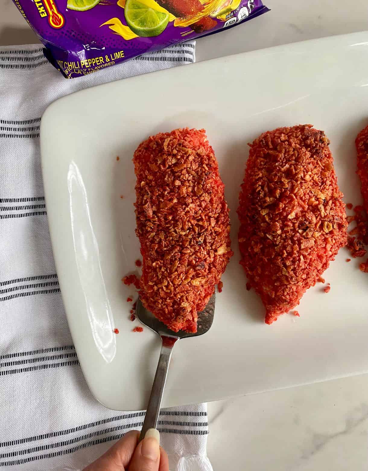 A platter with cooked Takis Chicken.