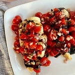 A platter of cooked Sheet Pan Bruschetta Chicken
