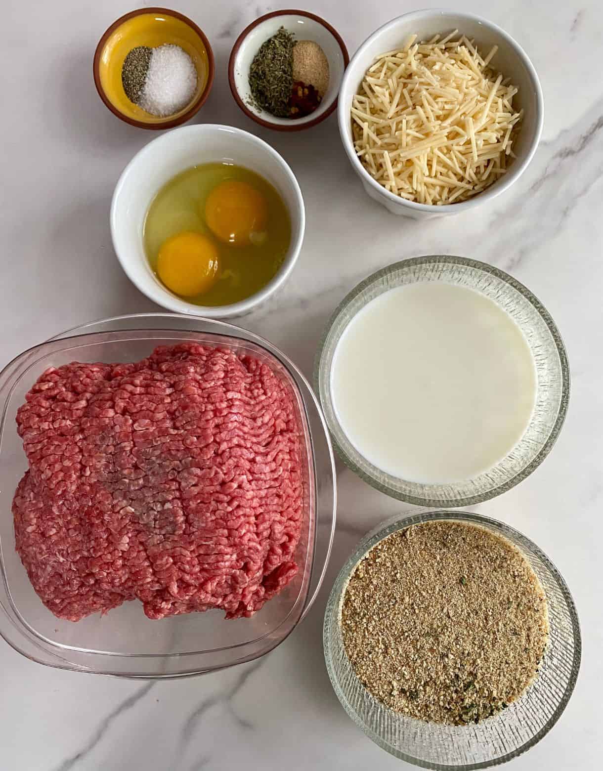 Raw ground beef, milk, bread crumbs, eggs, parmesan cheese, Italian seasoning, garlic powder, red pepper flakes, salt and pepper.