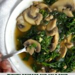 A bowl of Turkey Sausage and Kale Soup with a spoon.