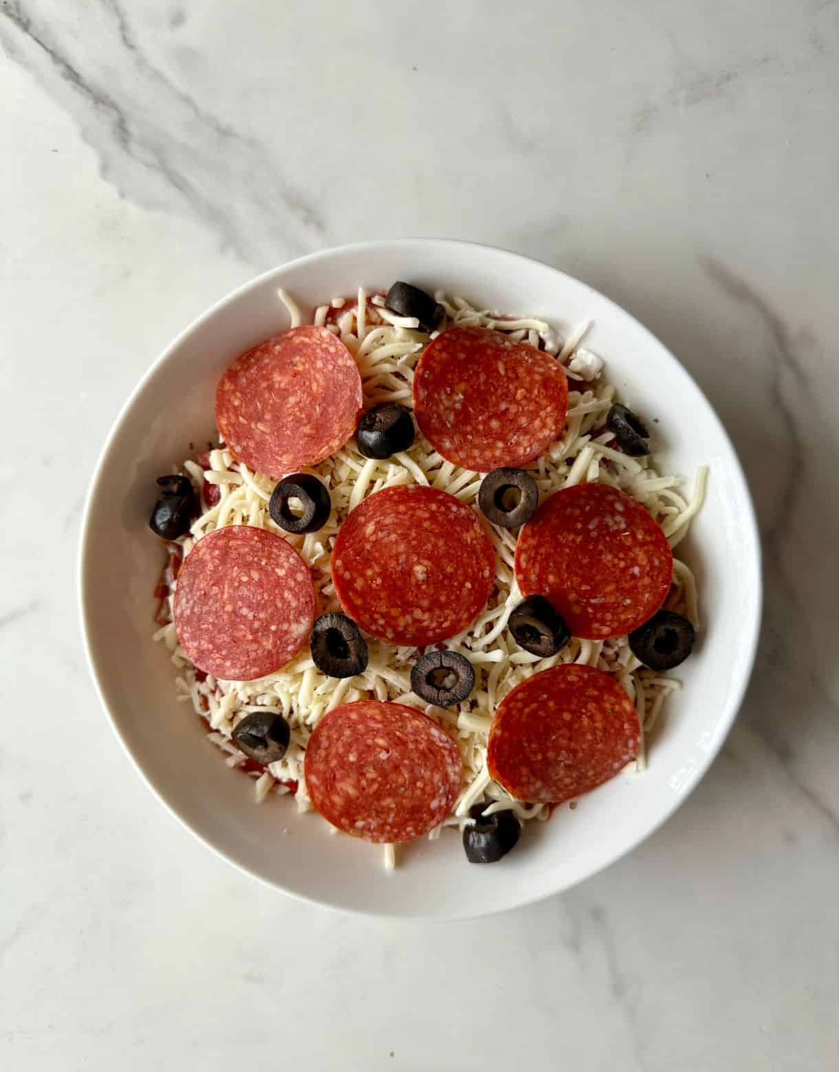 A pizza bowl ready to be cooked.