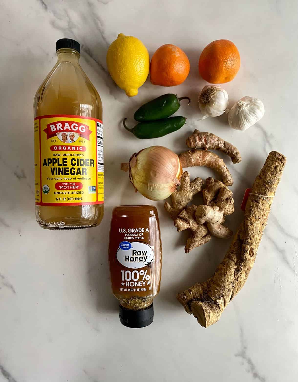 Apple cider vinegar, honey, onion, jalapenos, lemon, oranges, garlic, turmeric root, ginger root and horseradish root.