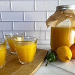 A jar of Immunity Shots plus three shots poured into small glasses.