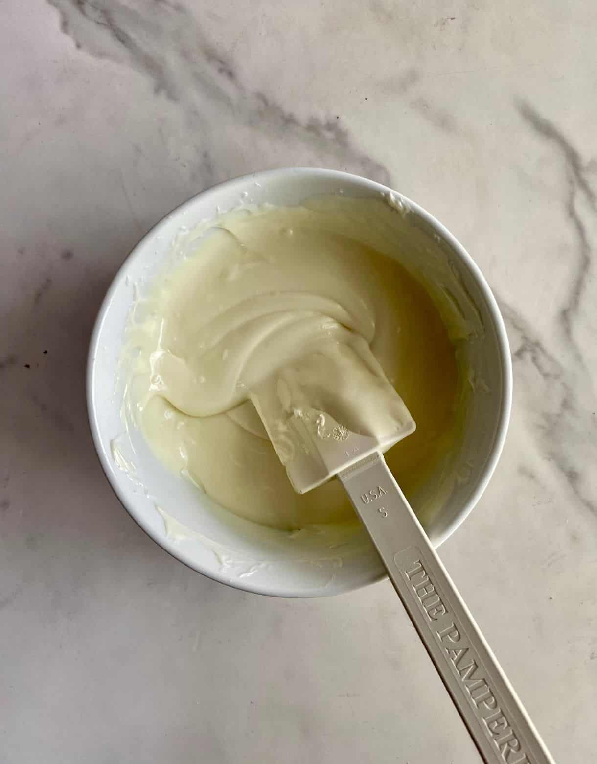 A bowl of melted white chocolate.