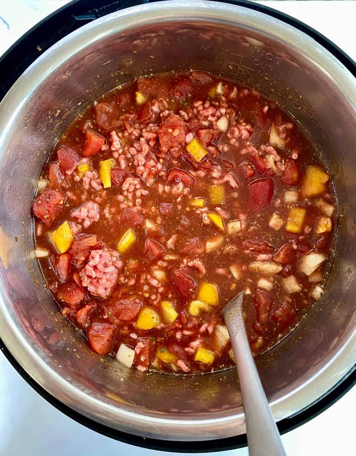 Ingredients for Slow Cooker Venison Chili added to the crockpot and stirred but not cooked.