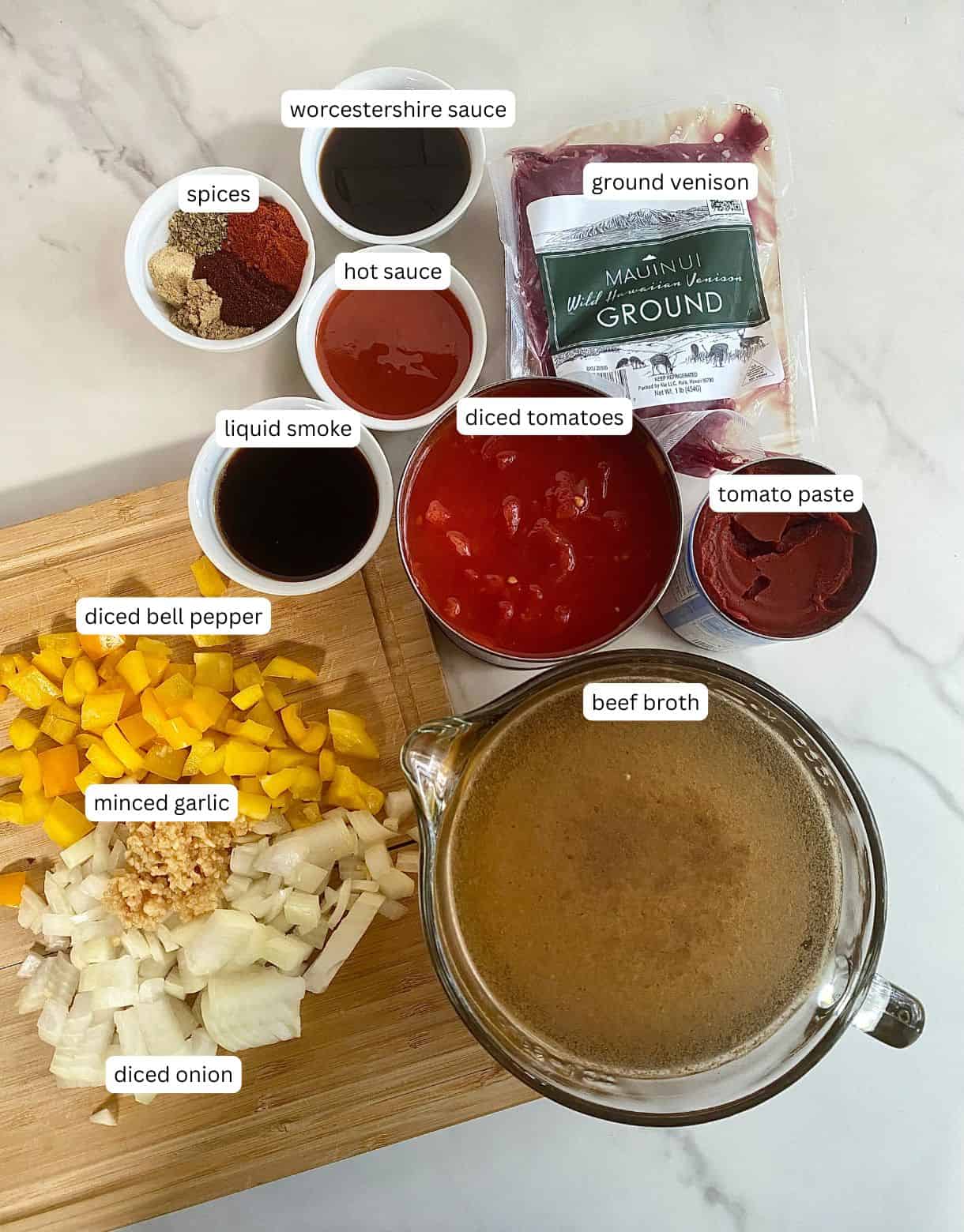 Beef broth, chopped onion, chopped bell pepper, minced garlic, diced tomatoes, tomato paste, ground venison, hot sauce, spices, Worcestershire sauce and liquid smoke.